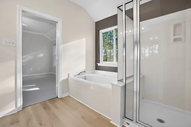 a bathroom with a bathtub a shower and a sink