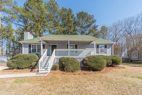 31 Sweetwater Pass Powder Springs, GA 30127 - Photo 1 of 1 a front view of a house with a yard and potted plants