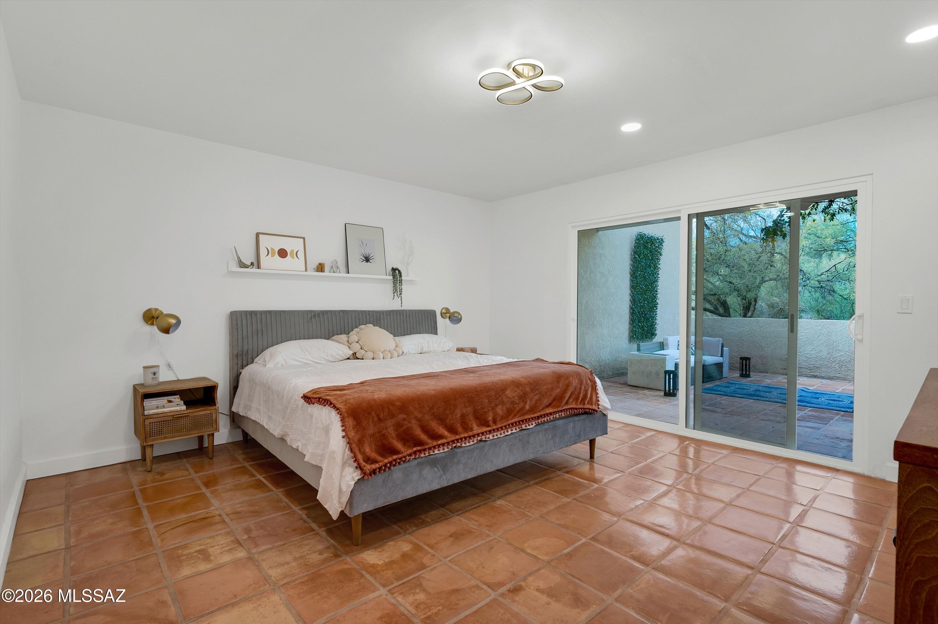6941 East Rivercrest Road Tucson, AZ 85750 - Photo 7 of 32 a bed sitting in a spacious bedroom next to a window
