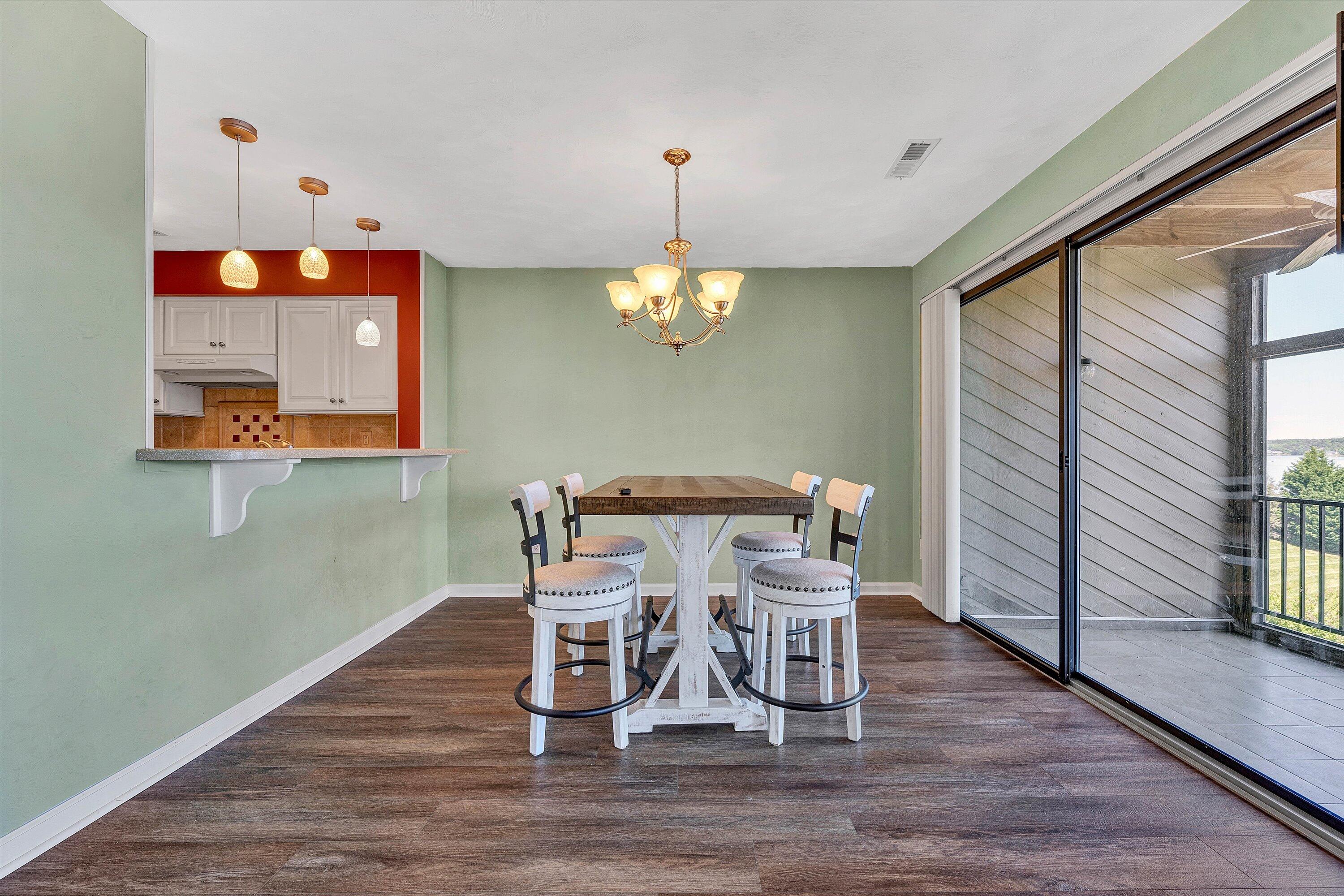 845 Gangplank Road, Unit 210 Moneta, VA 24121 - Photo 11 of 34 a dining room with furniture and wooden floor