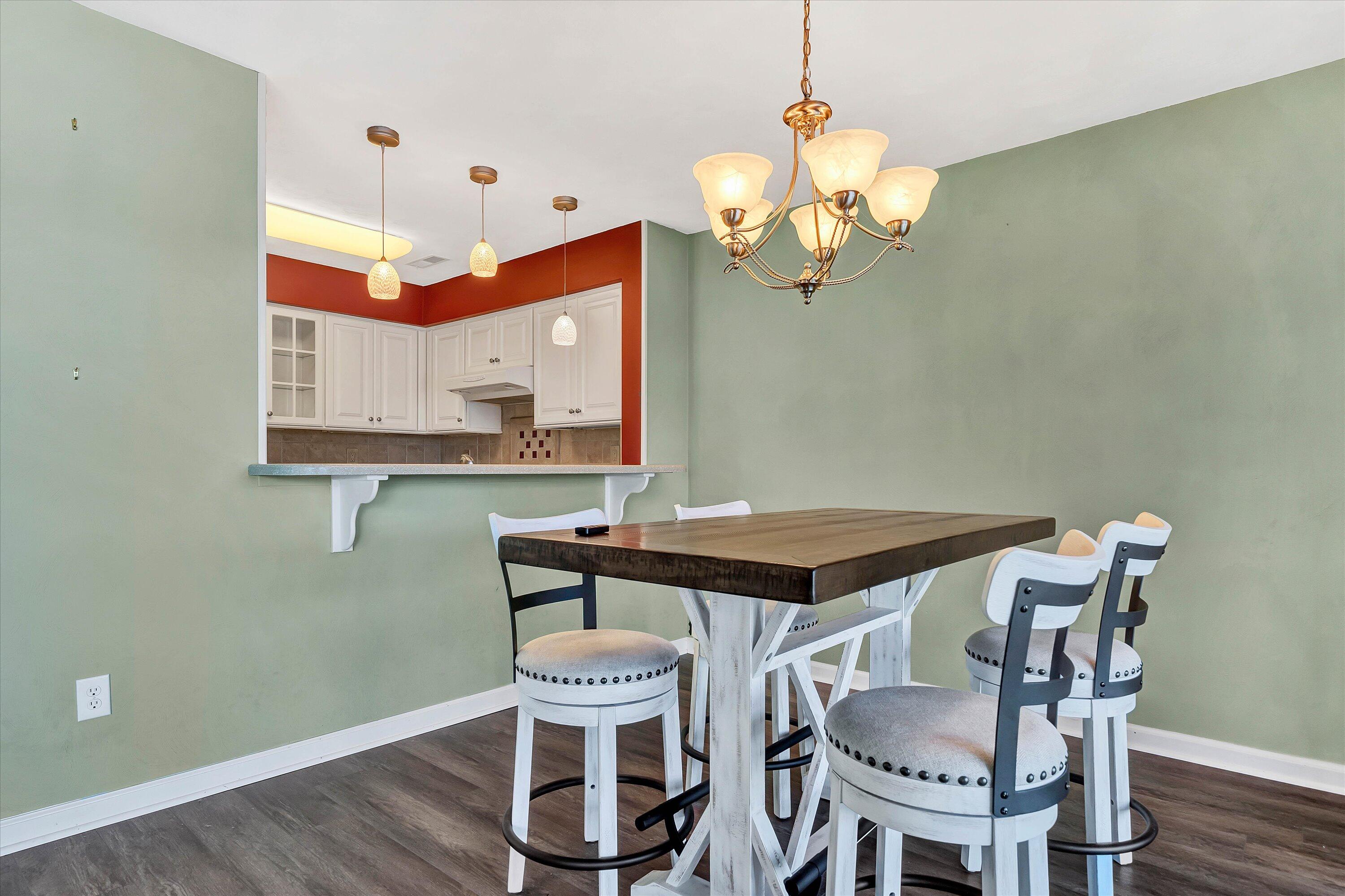 845 Gangplank Road, Unit 210 Moneta, VA 24121 - Photo 12 of 34 a view of a dining room with furniture and wooden floor