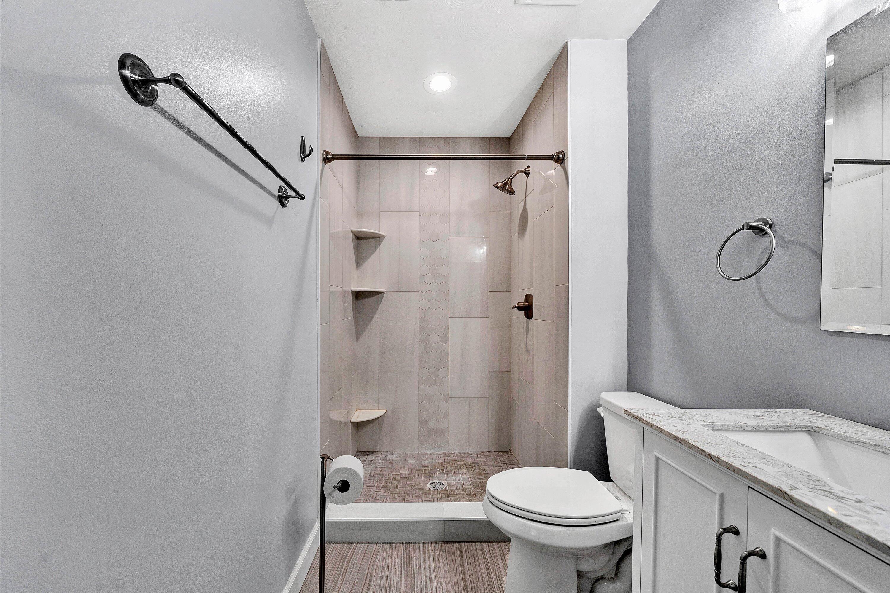 845 Gangplank Road, Unit 210 Moneta, VA 24121 - Photo 23 of 34 a bathroom with a granite countertop sink toilet and shower