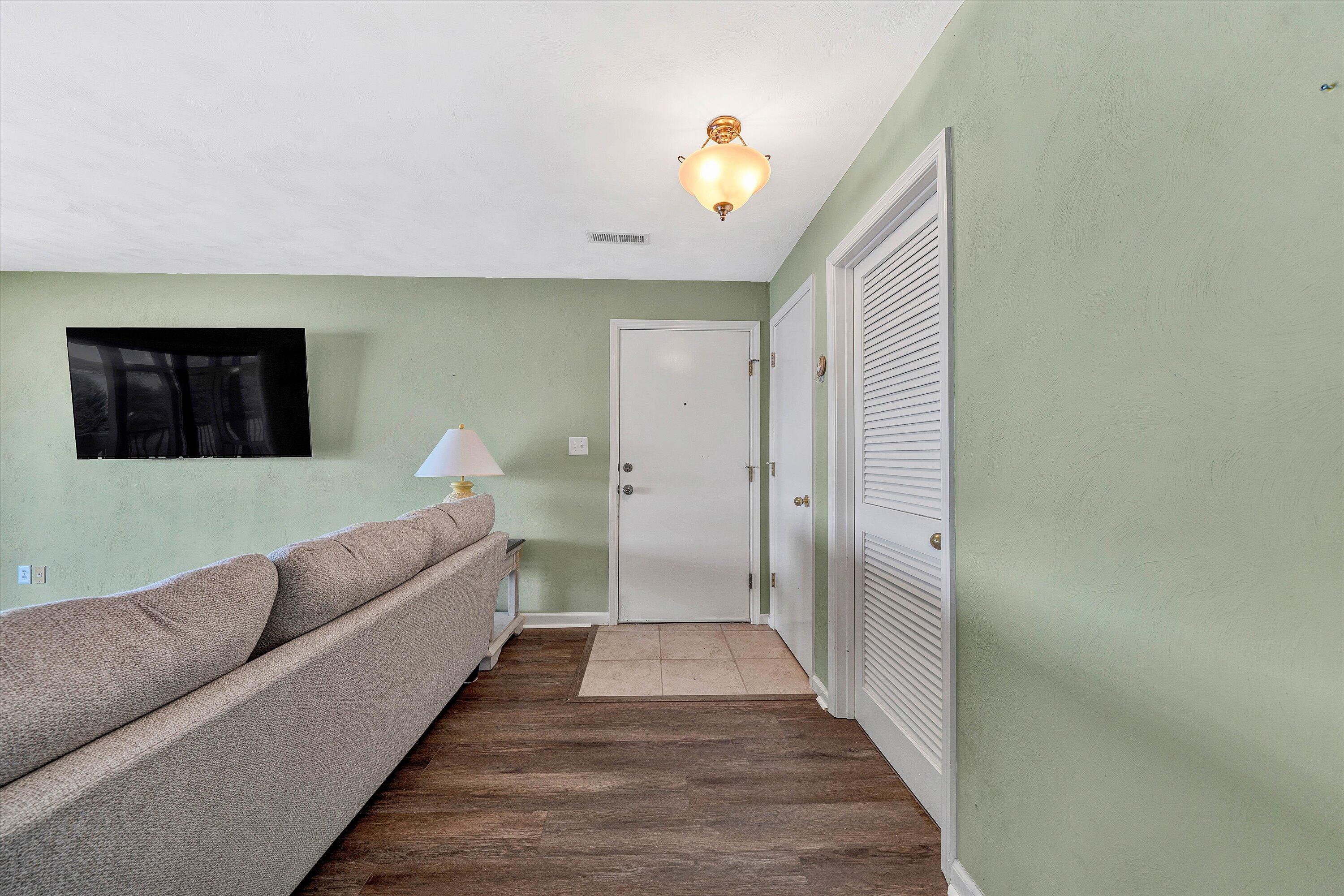 845 Gangplank Road, Unit 210 Moneta, VA 24121 - Photo 6 of 34 a living room with a couch and a potted plant