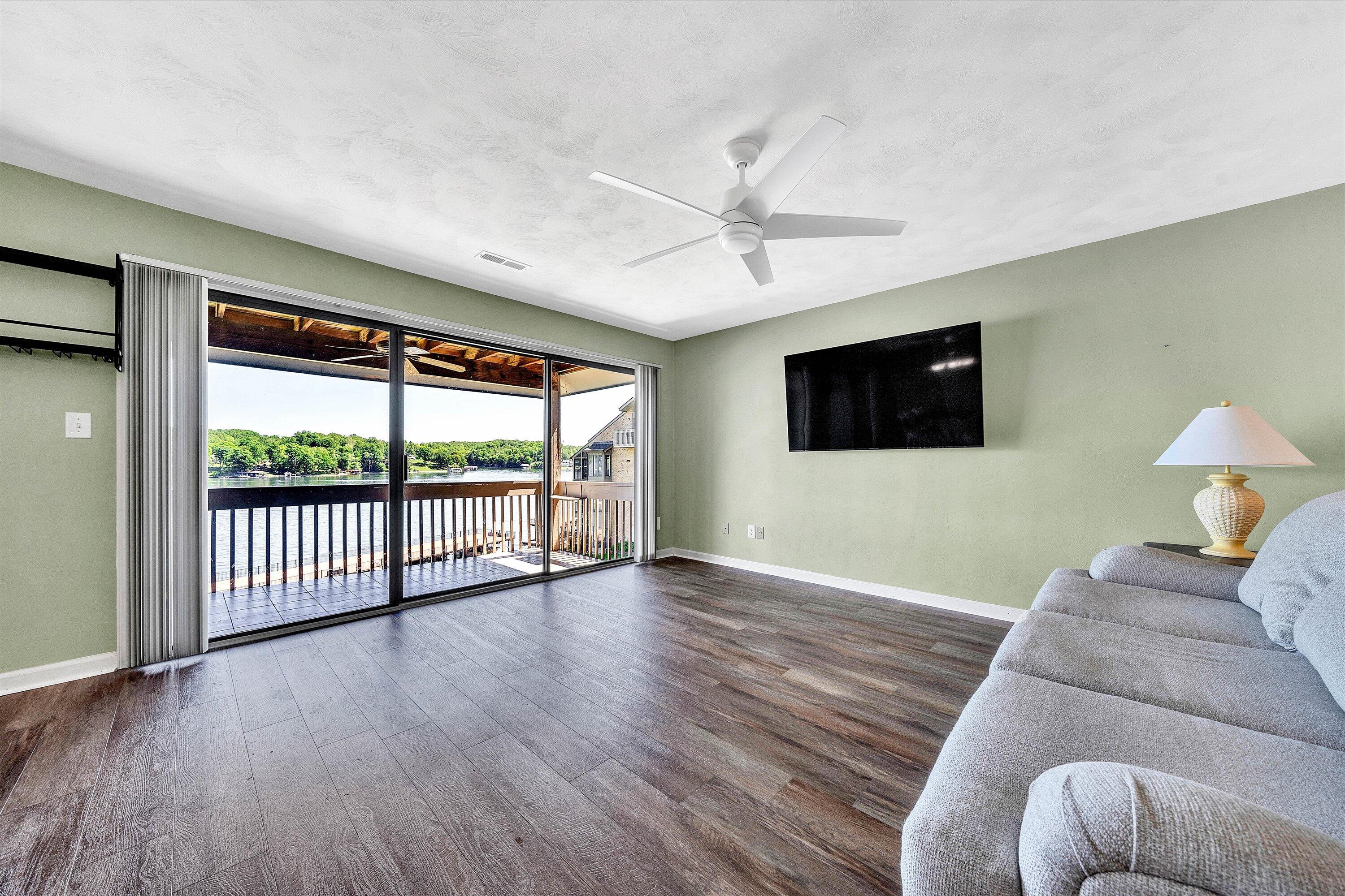 845 Gangplank Road, Unit 210 Moneta, VA 24121 - Photo 8 of 34 a living room with furniture tv and a floor to ceiling window