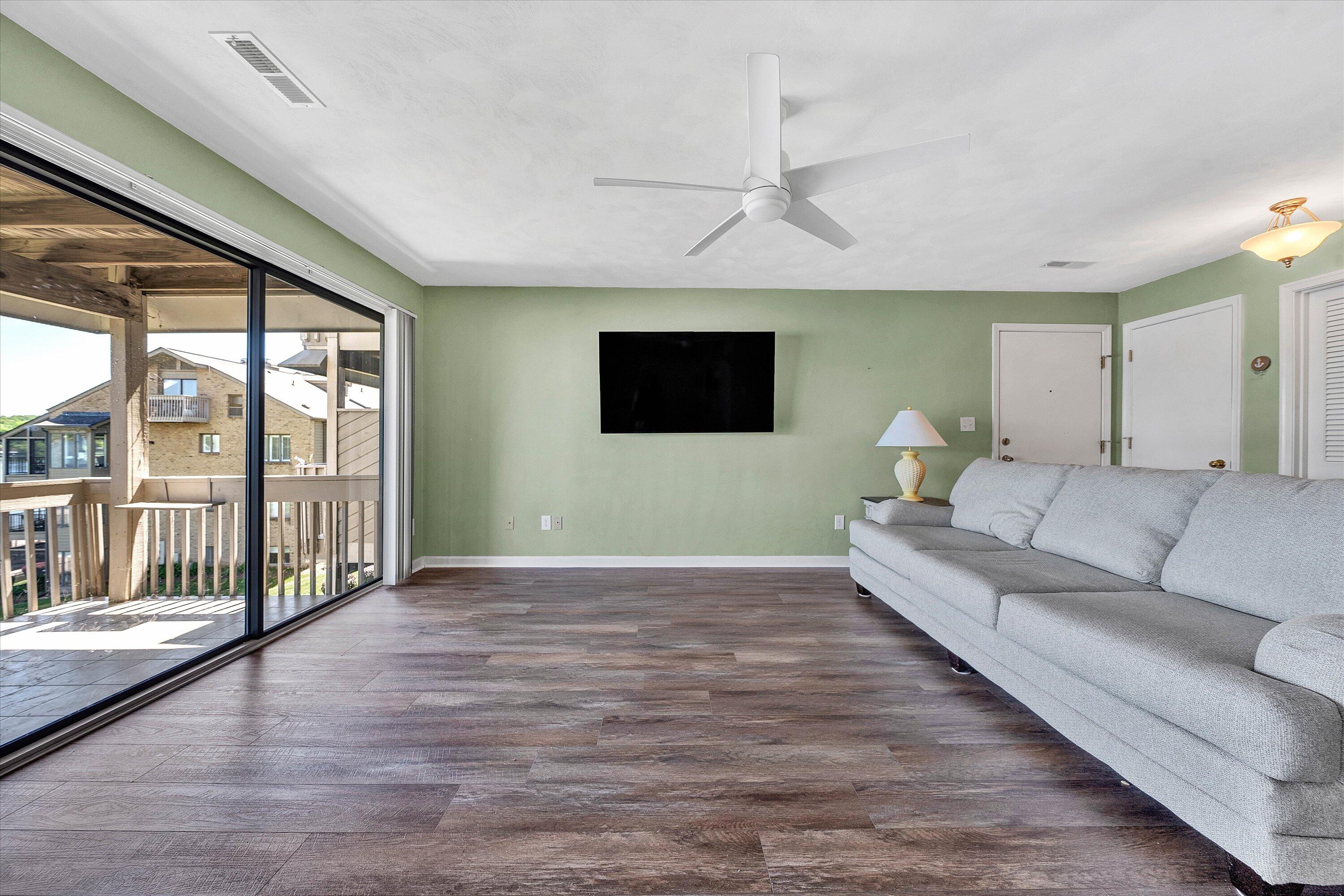 845 Gangplank Road, Unit 210 Moneta, VA 24121 - Photo 9 of 34 a living room with furniture and a flat screen tv