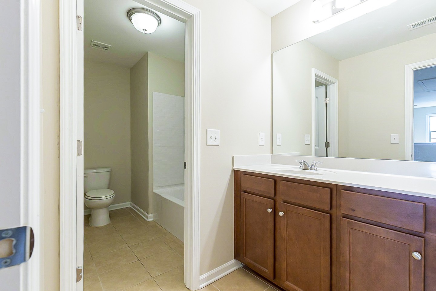 3005 Alan Drive Spring Hill, TN 37174 - Photo 23 of 31 a bathroom with a granite countertop sink a toilet and a mirror