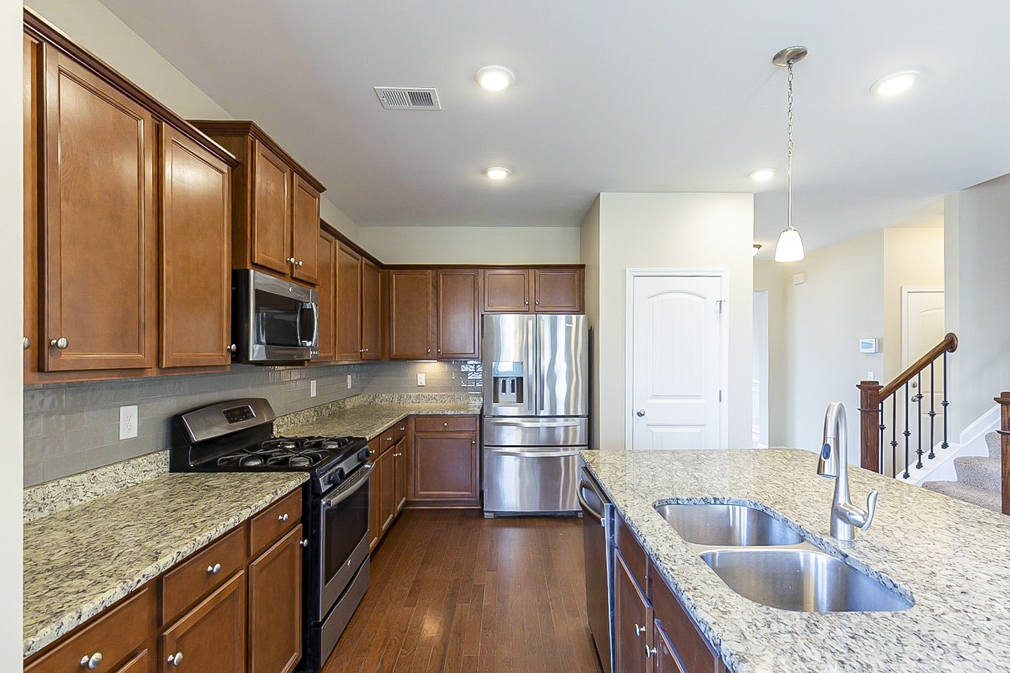 3005 Alan Drive Spring Hill, TN 37174 - Photo 4 of 31 a kitchen with stainless steel appliances granite countertop a sink a stove and a refrigerator
