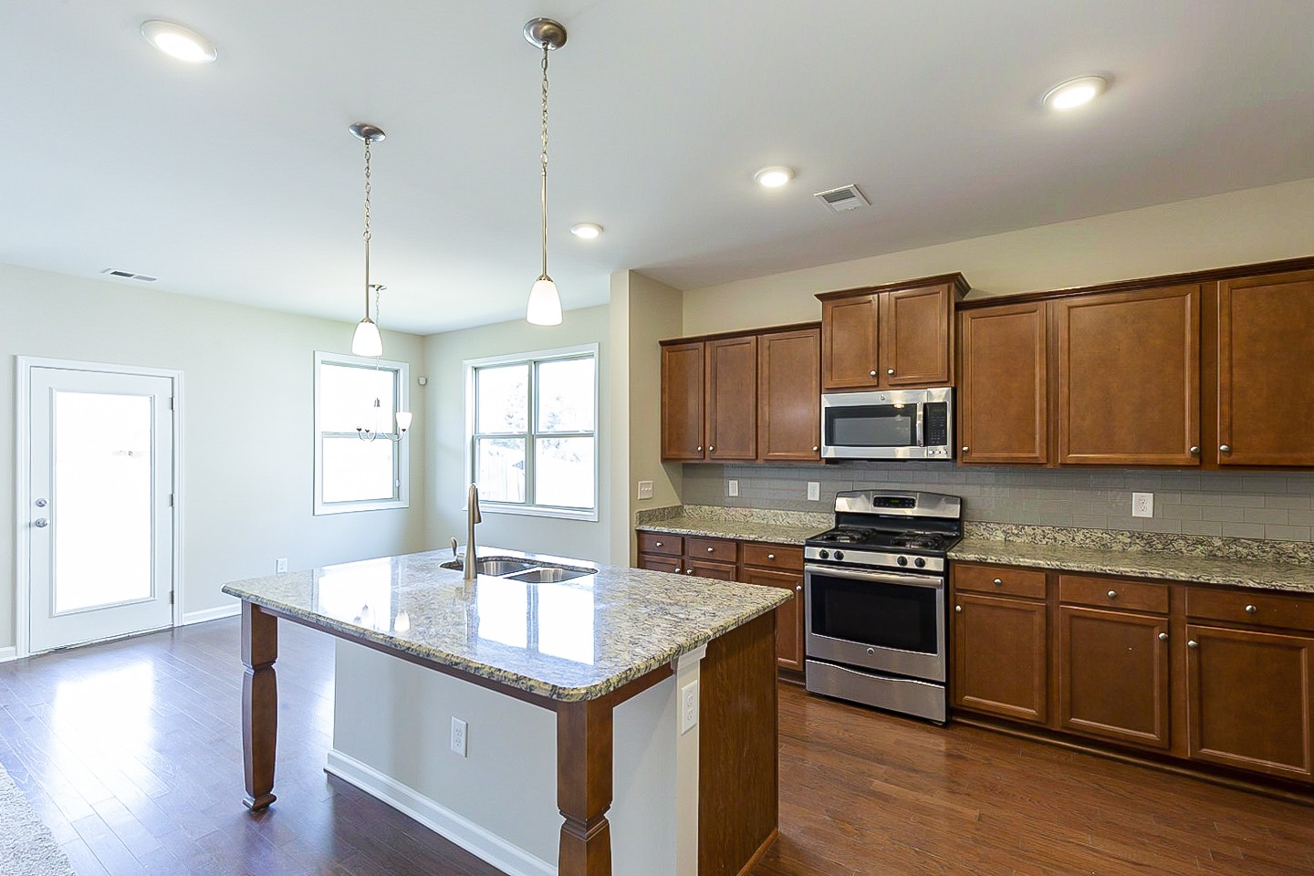 3005 Alan Drive Spring Hill, TN 37174 - Photo 9 of 31 a kitchen with stainless steel appliances granite countertop a sink stove and wooden floor