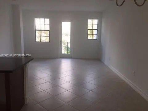 11332 Southwest 15th Street Pembroke Pines, FL 33025 - Photo 2 of 6 an empty room with windows