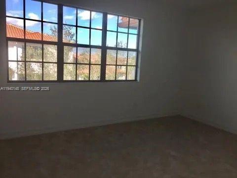 11332 Southwest 15th Street Pembroke Pines, FL 33025 - Photo 3 of 6 an empty room with a window