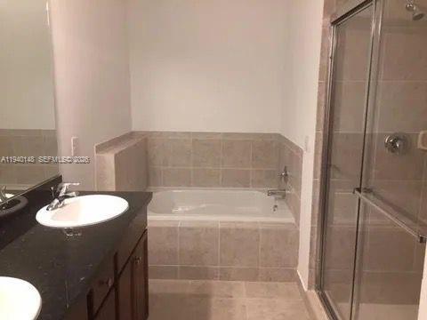 11332 Southwest 15th Street Pembroke Pines, FL 33025 - Photo 5 of 6 a bathroom with a sink and a mirror