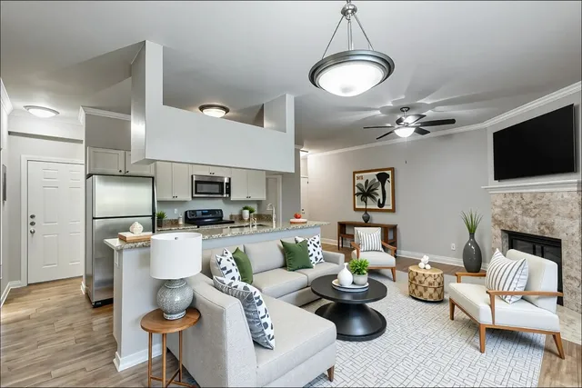 a living room with furniture a fireplace and a flat screen tv