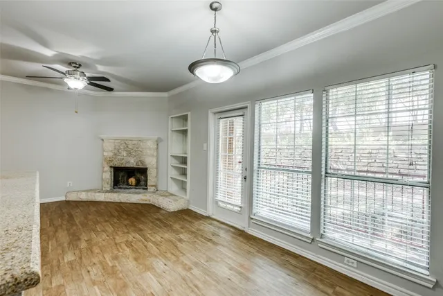a view of an empty room with a fireplace and a window