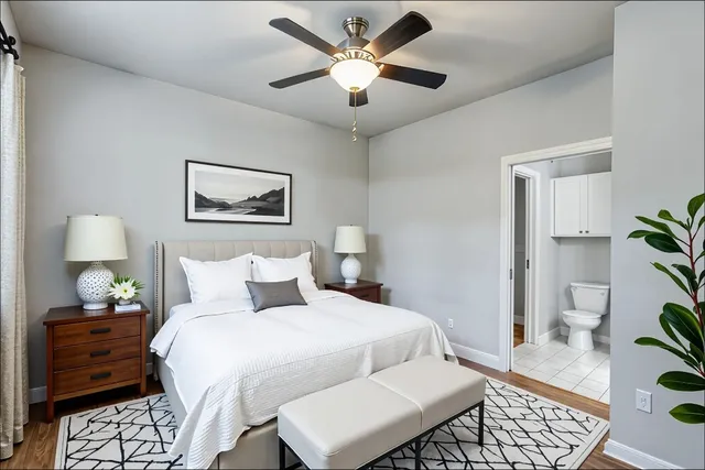 a bedroom with a bed and a potted plant