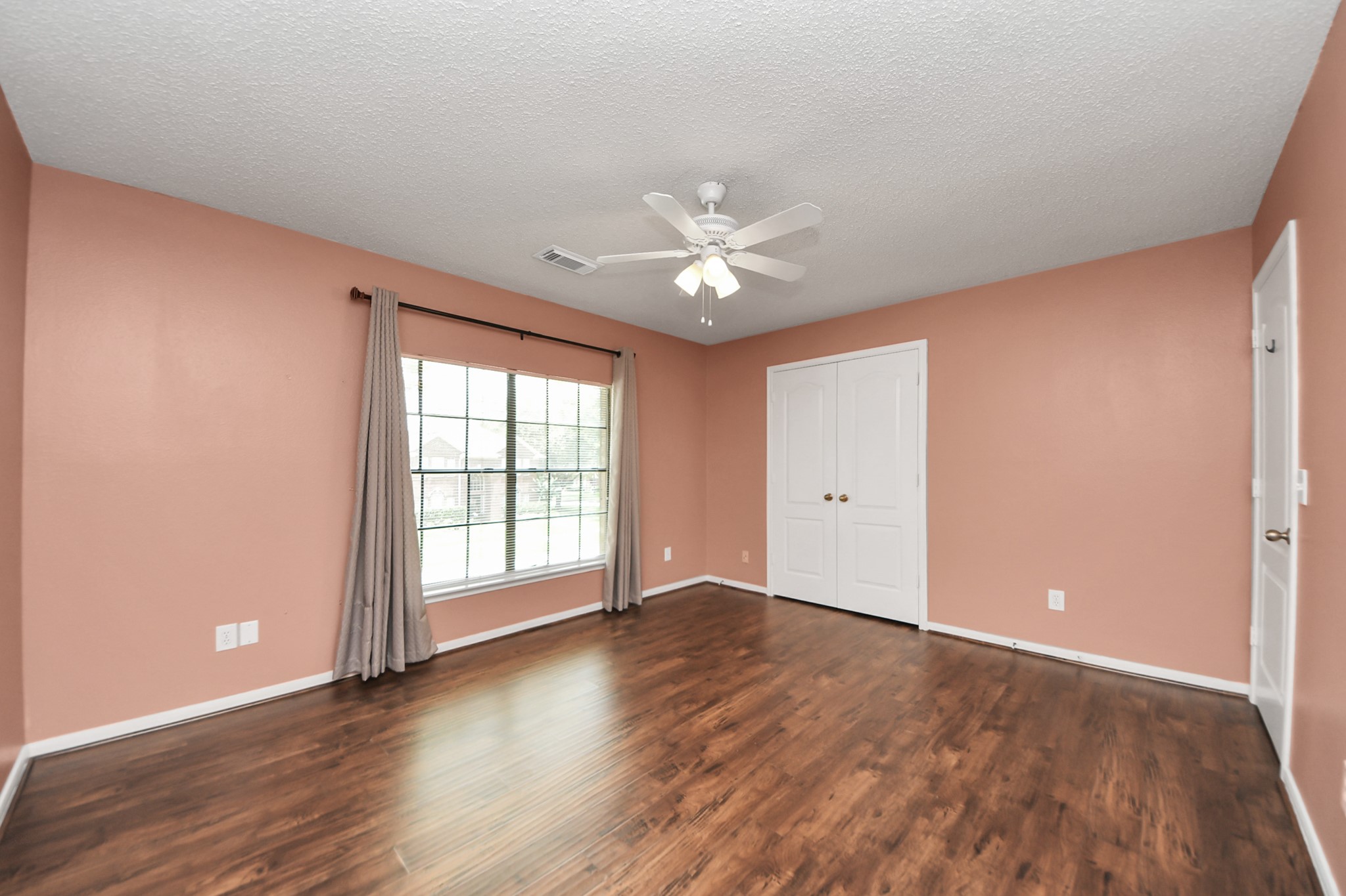 3107 Dulaney Road Houston, TX 77084 - Photo 42 of 50 a view of an empty room with window and wooden floor
