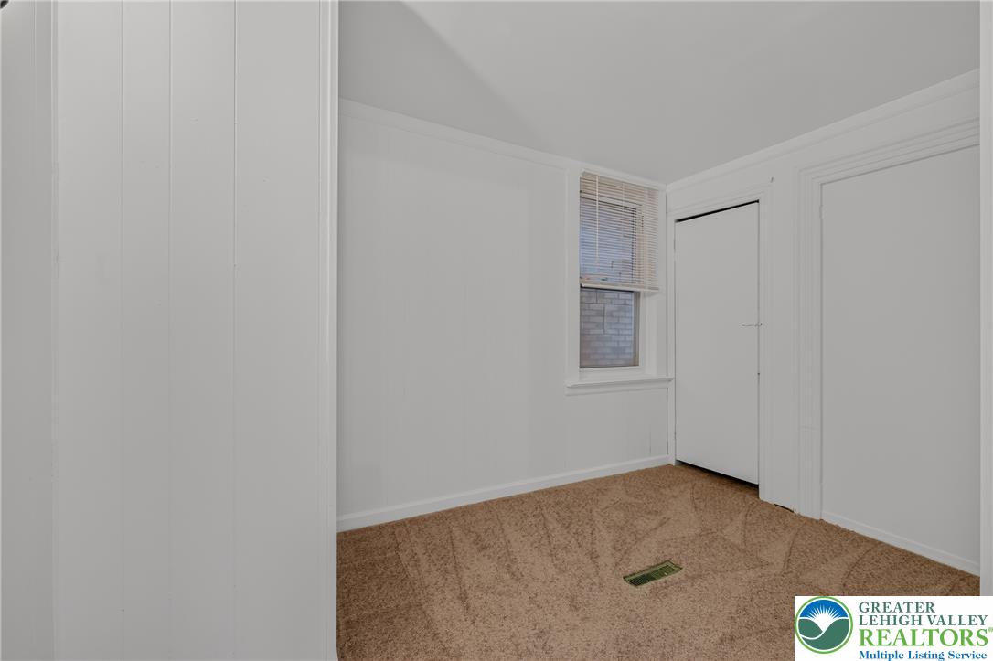 313 Main Street Slatington, PA 18080 - Photo 18 of 73 Comfortable bedroom featuring soft carpet and a window offering natural light and neighborhood views.