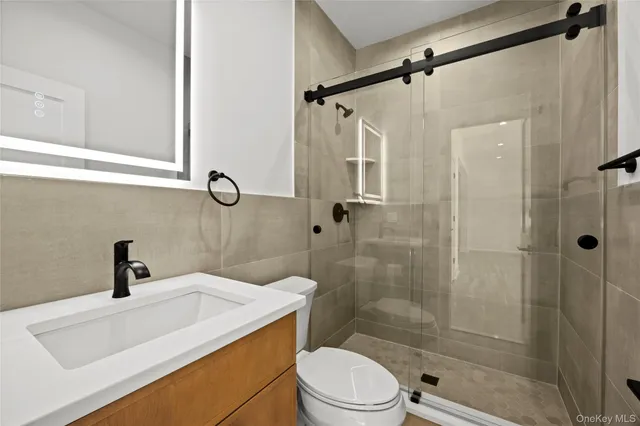 a view of a big room with wooden floor and windows
