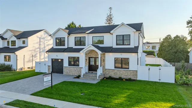 a front view of a house with a garden