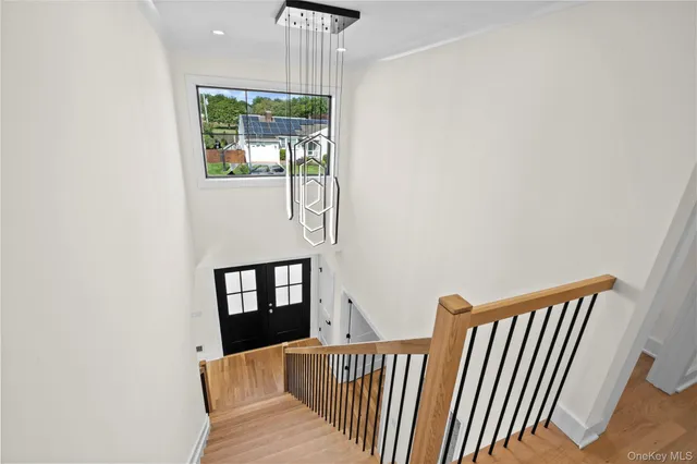 a view of a hallway with wooden floor and staircase