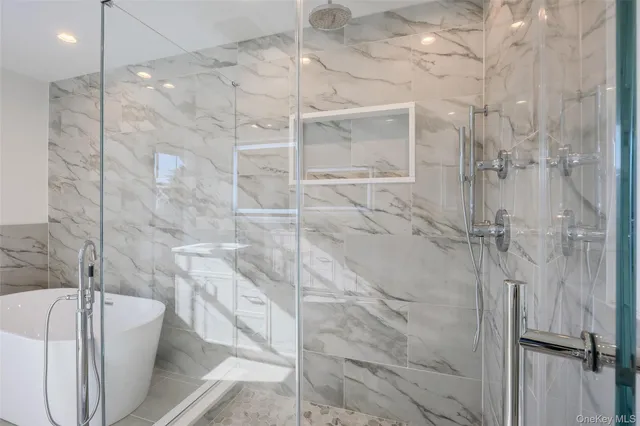 a spacious bathroom with a double vanity sink a mirror and a shower