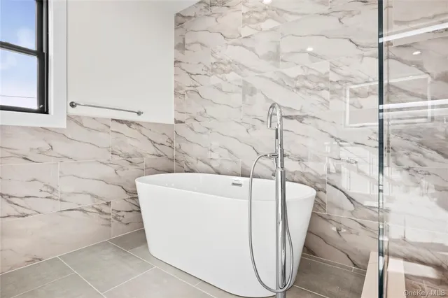 a bathroom with a bathtub and shower