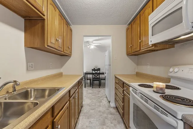 a kitchen with stainless steel appliances granite countertop a sink and cabinets