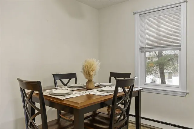 a view of a dining room with furniture and window