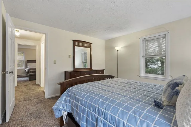 a bedroom with a bed and a mirror