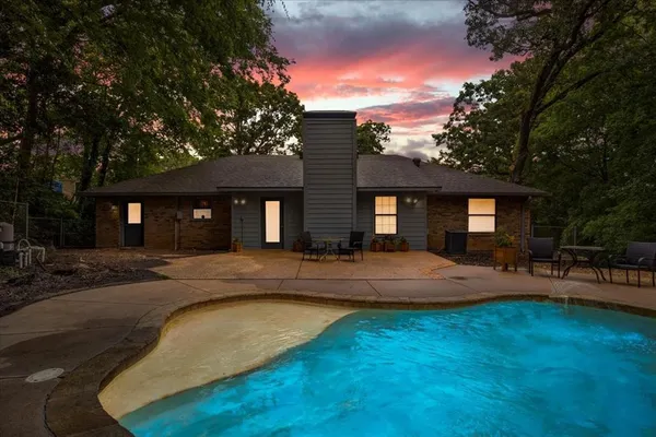 a view of a house with swimming pool and sitting area