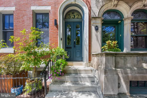 a view of a brick house with potted plants