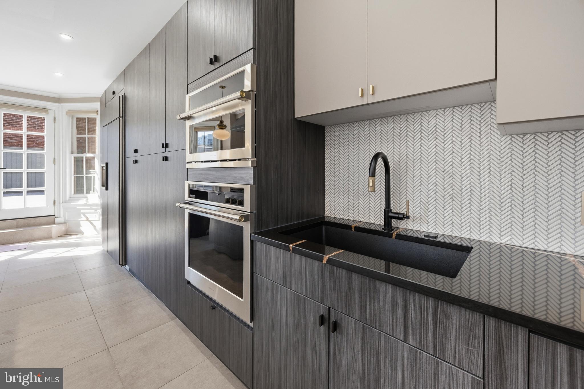552 North 18th Street Philadelphia, PA 19130 - Photo 11 of 51 a kitchen with granite countertop a refrigerator and a sink