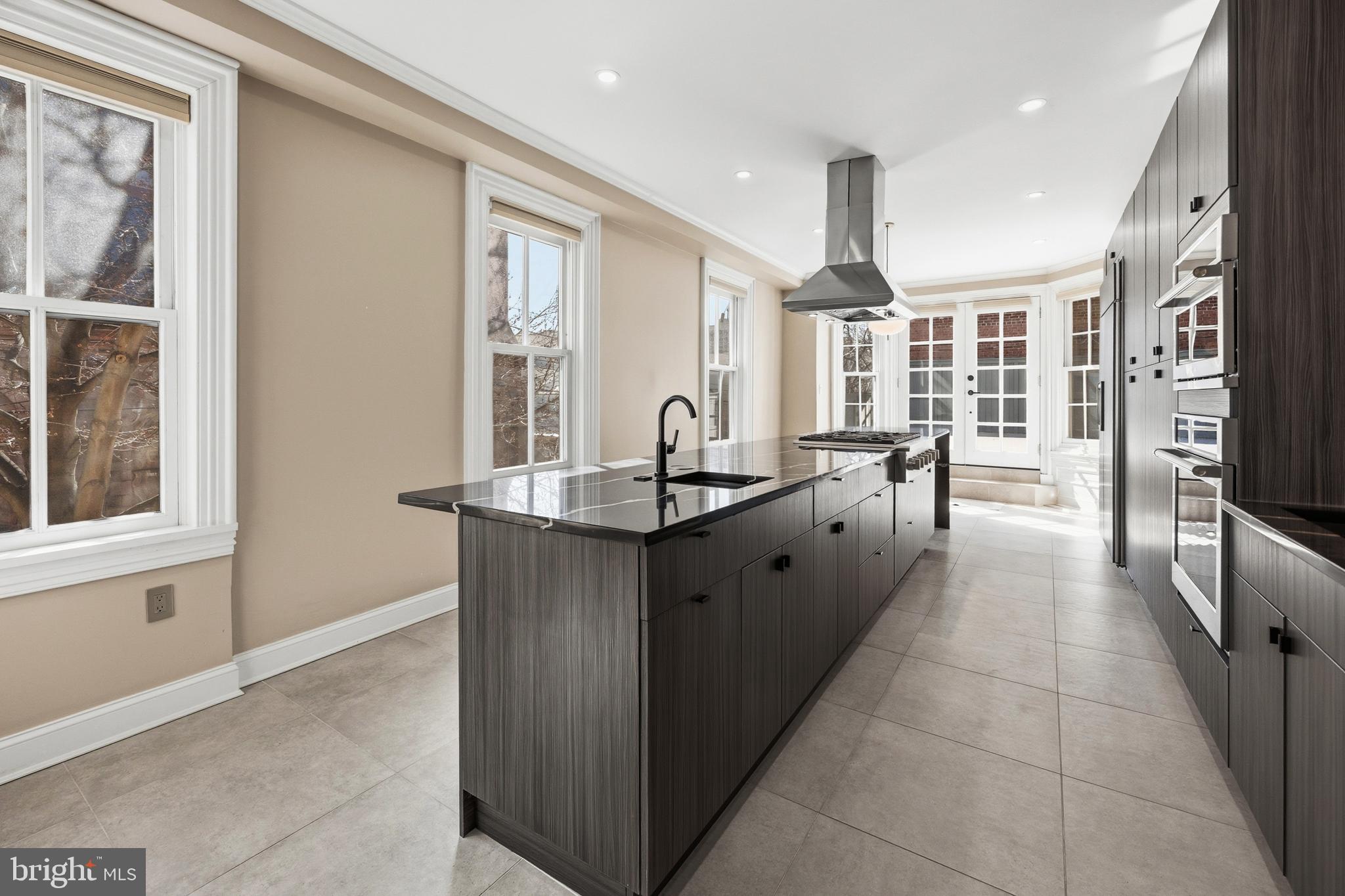 552 North 18th Street Philadelphia, PA 19130 - Photo 12 of 51 a dining hall with stainless steel appliances granite countertop a stove and a sink