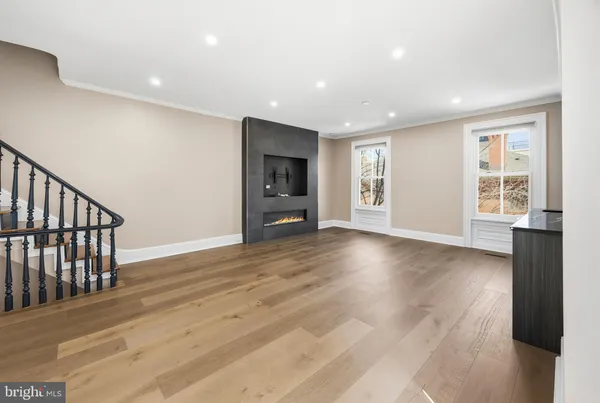 a view of a livingroom with wooden floor and window