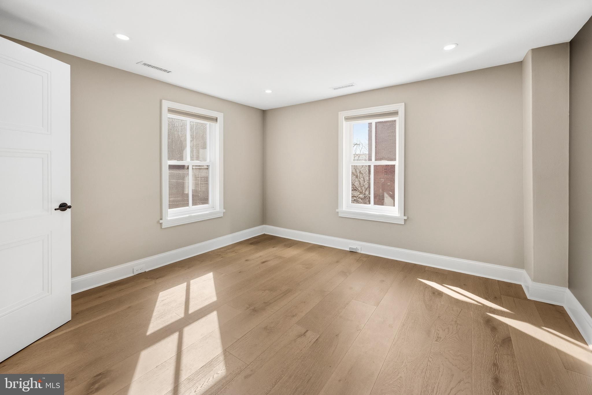 552 North 18th Street Philadelphia, PA 19130 - Photo 32 of 51 an empty room with wooden floor and windows