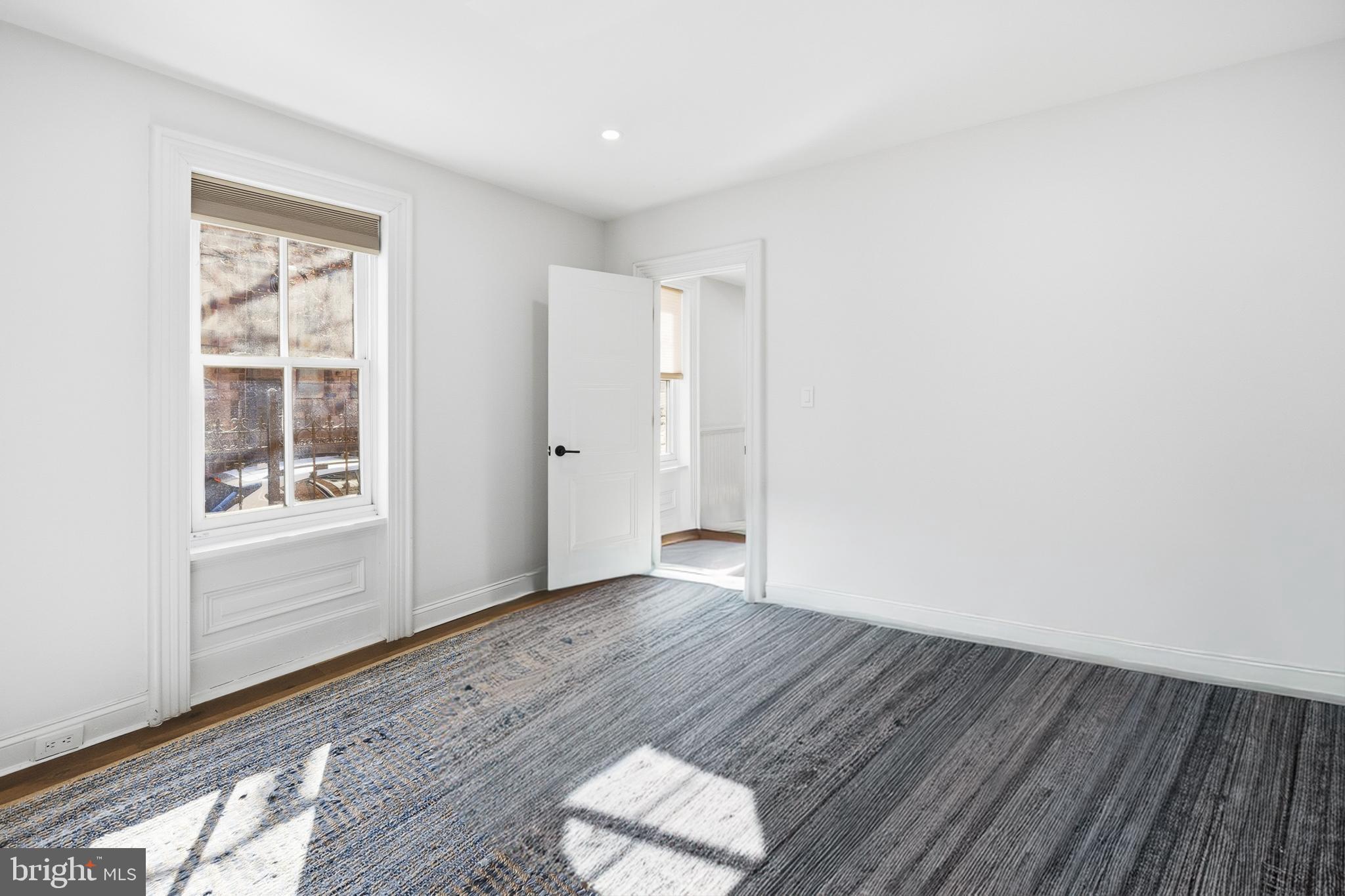 552 North 18th Street Philadelphia, PA 19130 - Photo 45 of 51 an empty room with wooden floor and windows