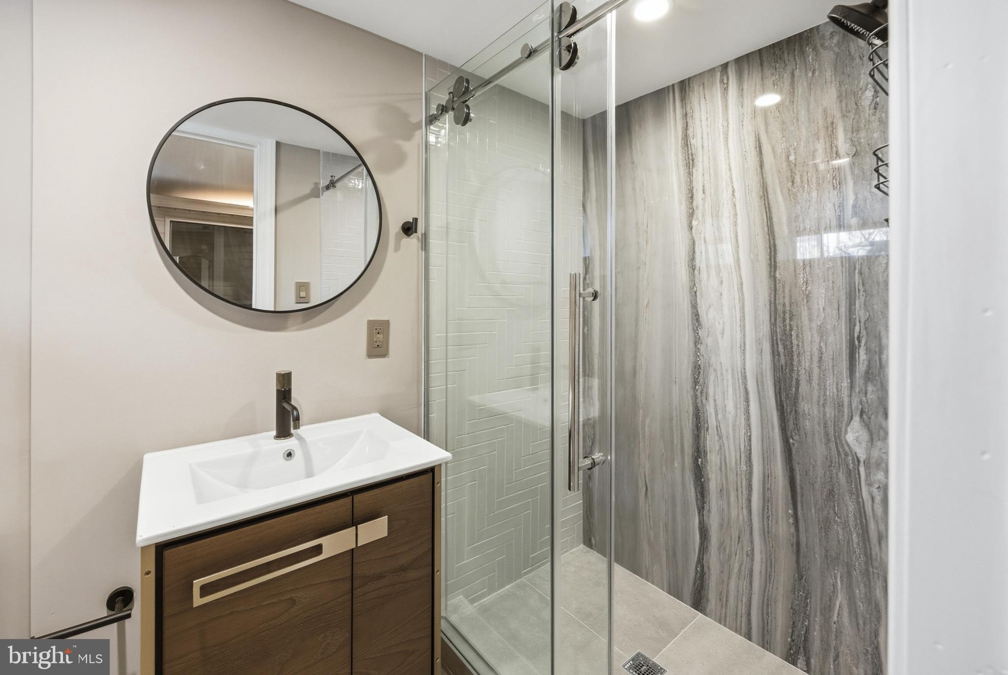 552 North 18th Street Philadelphia, PA 19130 - Photo 51 of 51 a bathroom with a sink a mirror a vanity and a shower