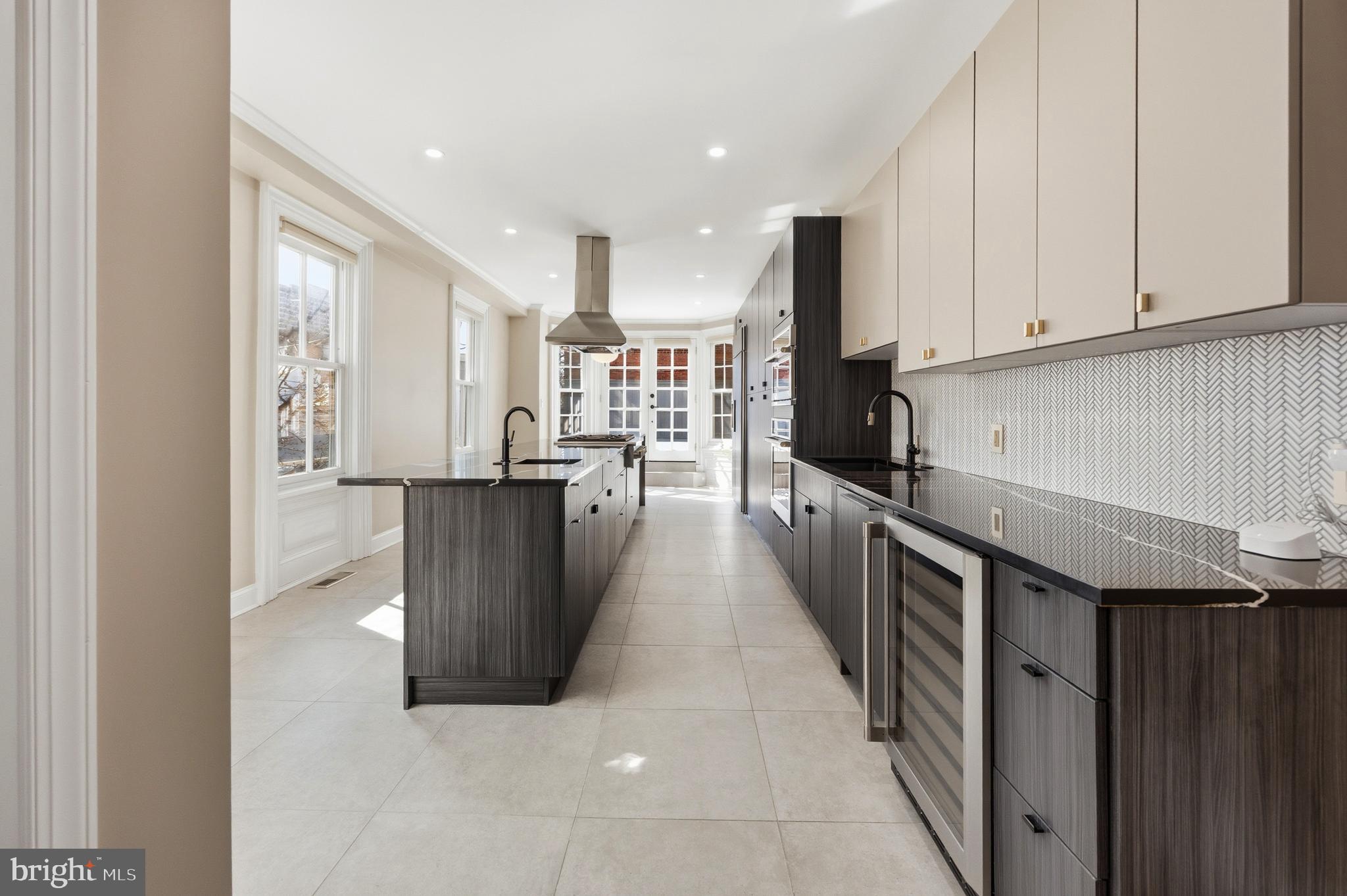 552 North 18th Street Philadelphia, PA 19130 - Photo 8 of 51 a view of a kitchen with kitchen island wooden floors stainless steel appliances