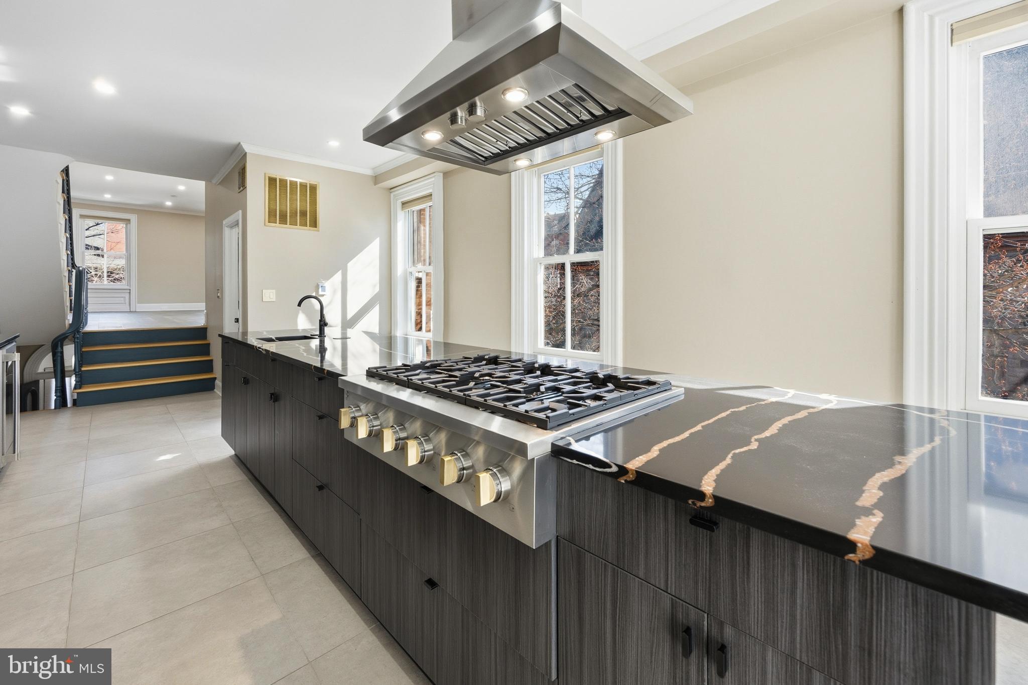 552 North 18th Street Philadelphia, PA 19130 - Photo 9 of 51 a kitchen with stainless steel appliances granite countertop a stove a sink and a refrigerator