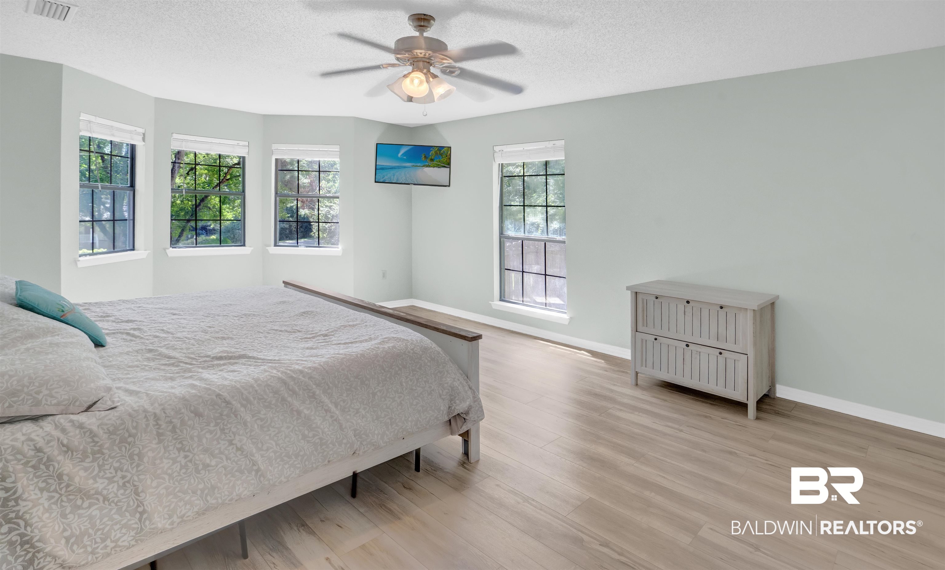 30871 Stanton Road Spanish Fort, AL 36527 - Photo 24 of 35 Bedroom featuring ceiling fan, light hardwood / wood-style flooring, and a textured ceiling