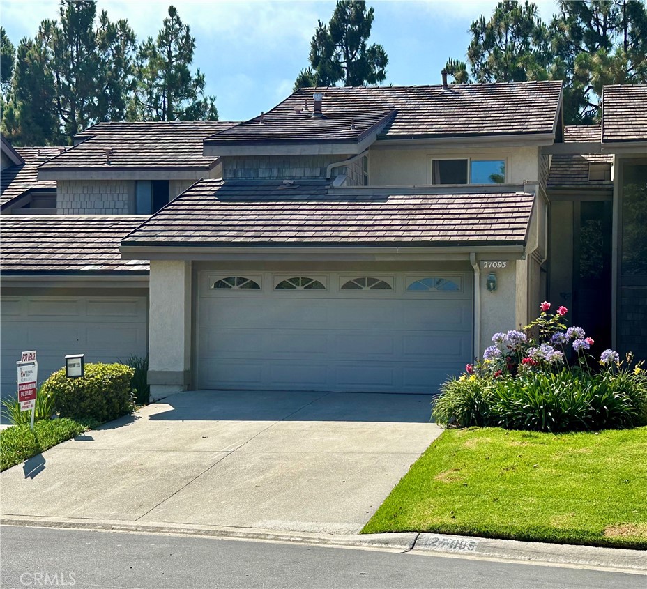 27095 Mill Pond Road, Unit 47 Dana Point, CA 92624 - Photo 1 of 45 a front view of a house with a garden