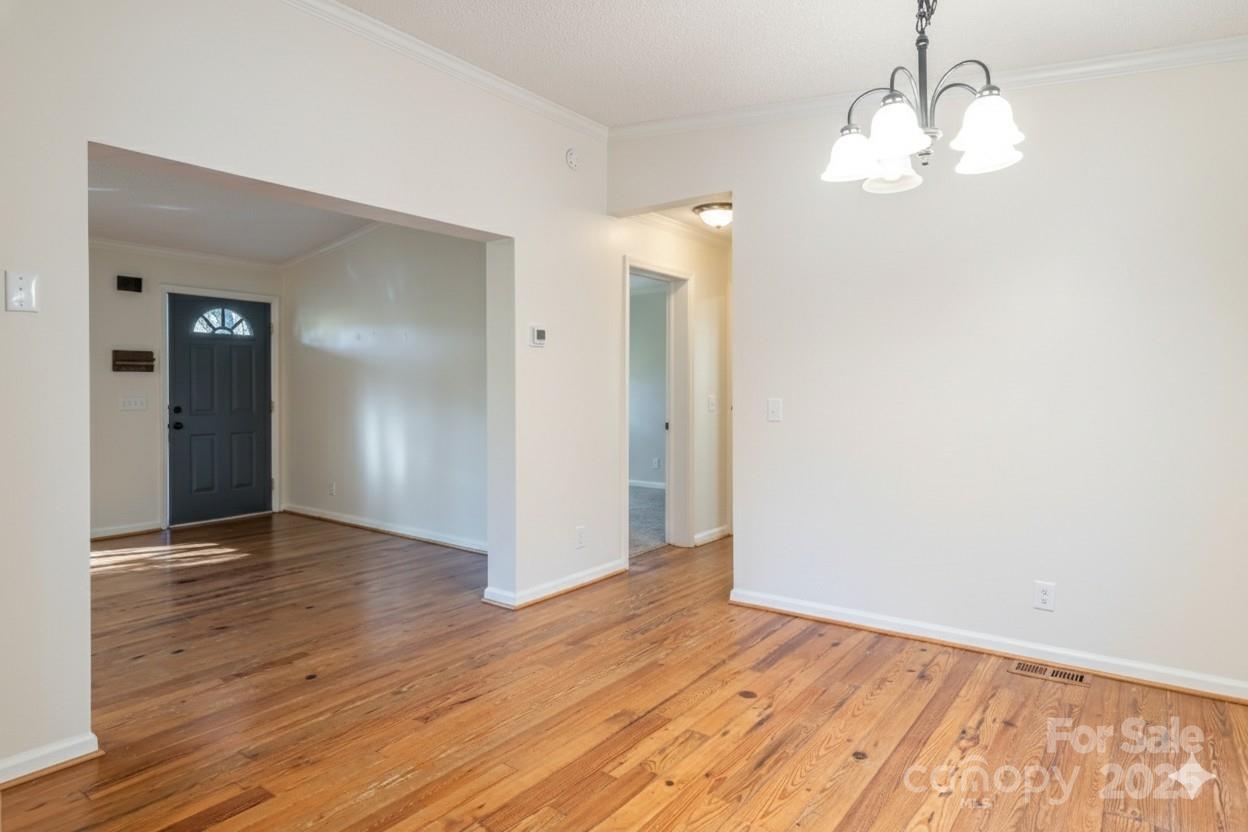 334 Foxden Road Mars Hill, NC 28754 - Photo 11 of 43 an empty room with wooden floor and mirror