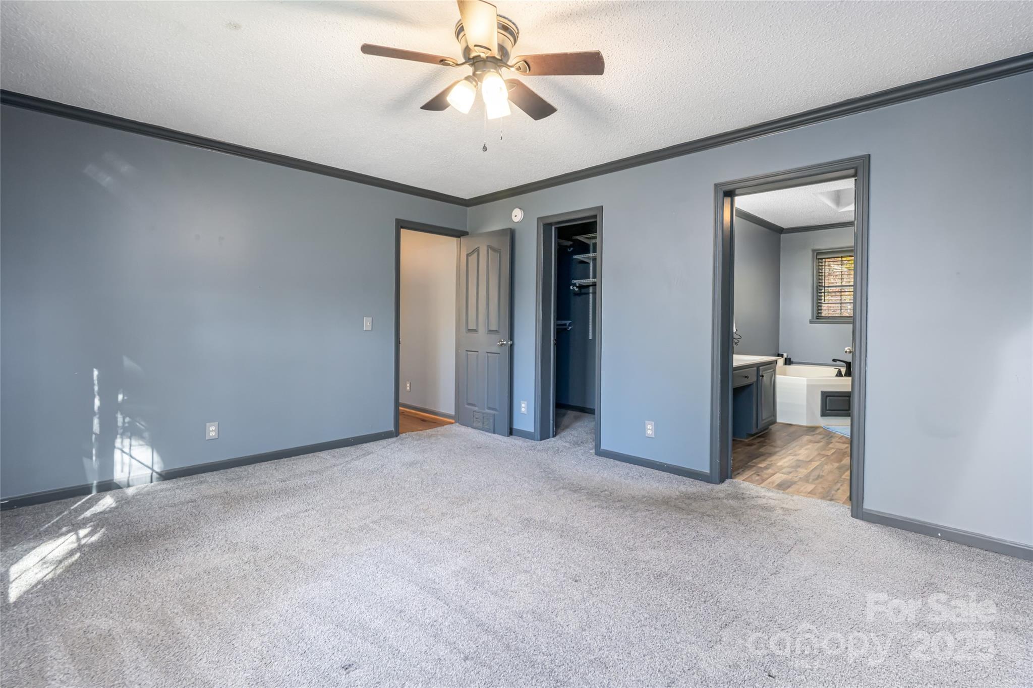 334 Foxden Road Mars Hill, NC 28754 - Photo 12 of 43 a view of a big room with chandelier fan and windows