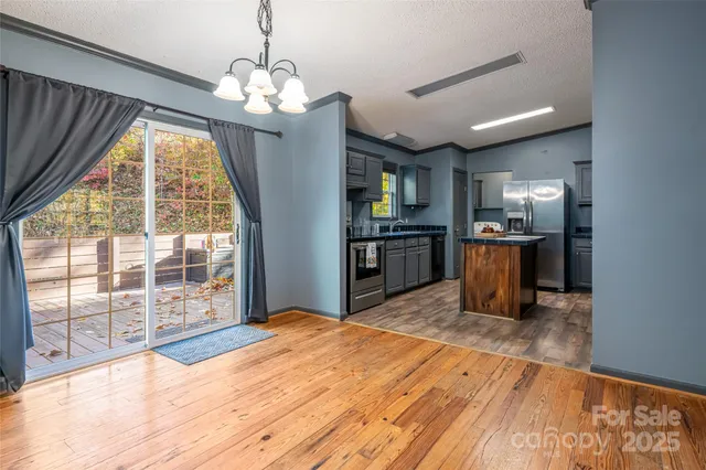 a view of a kitchen with microwave and windows