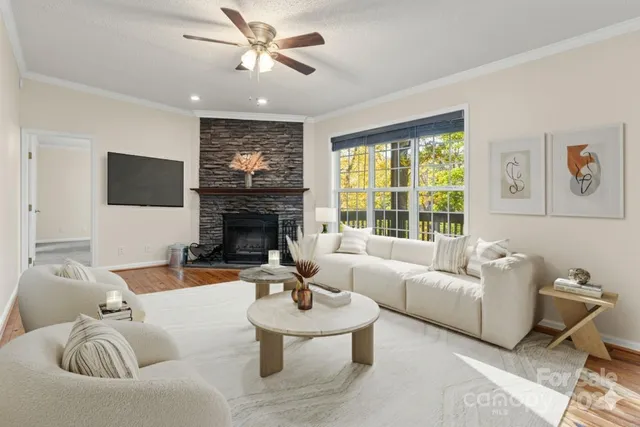 a living room with furniture a fireplace and a flat screen tv