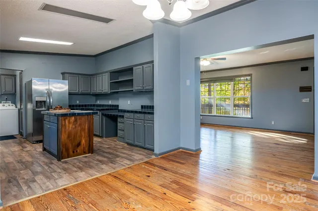 a kitchen with stainless steel appliances granite countertop a refrigerator a sink a stove and oven