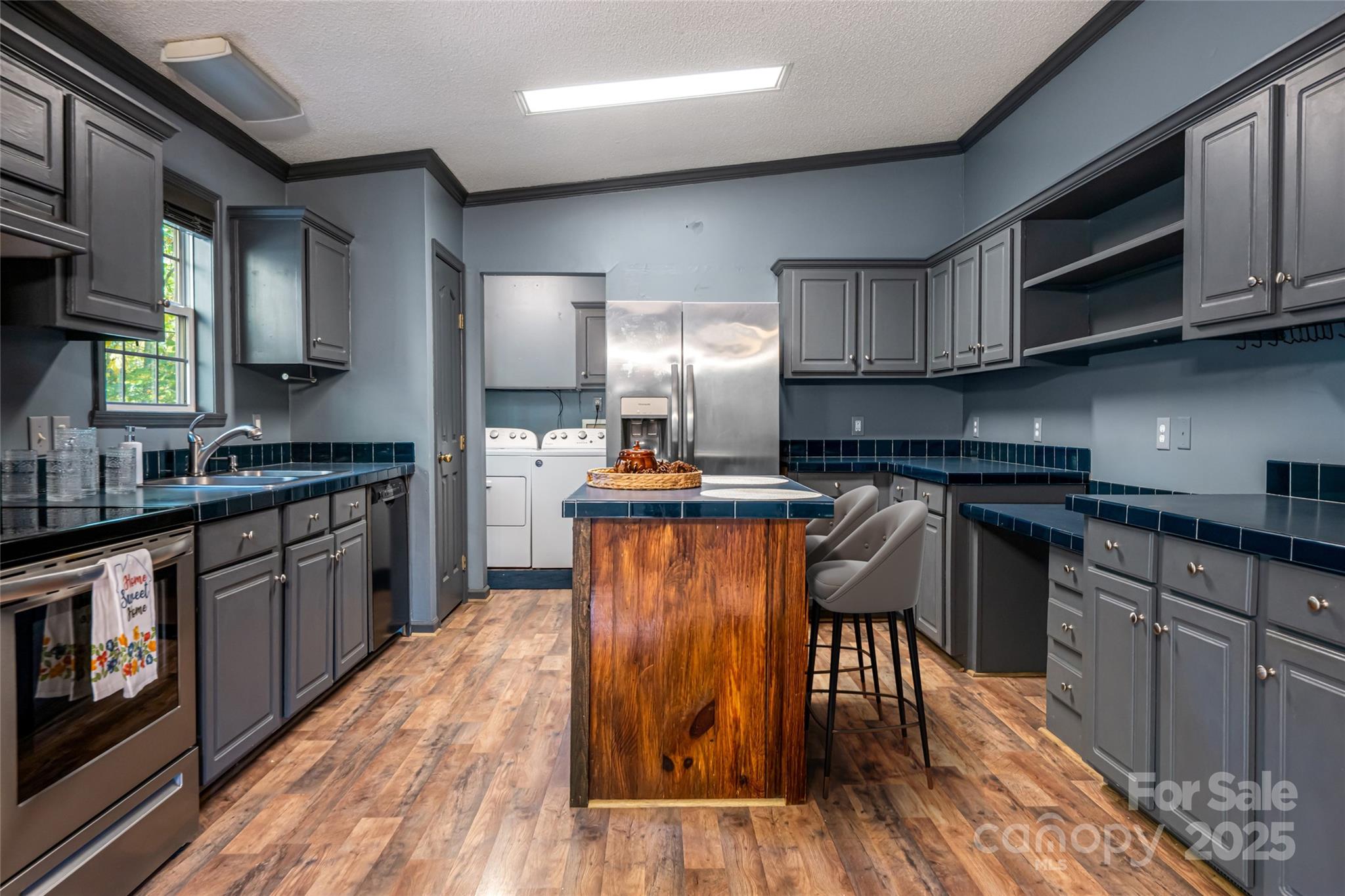334 Foxden Road Mars Hill, NC 28754 - Photo 7 of 43 a kitchen with granite countertop wooden floors stainless steel appliances and a sink