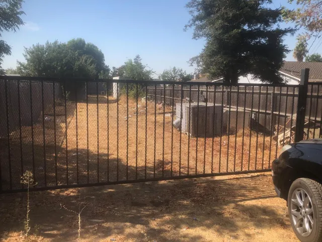 a view of backyard with wooden fence