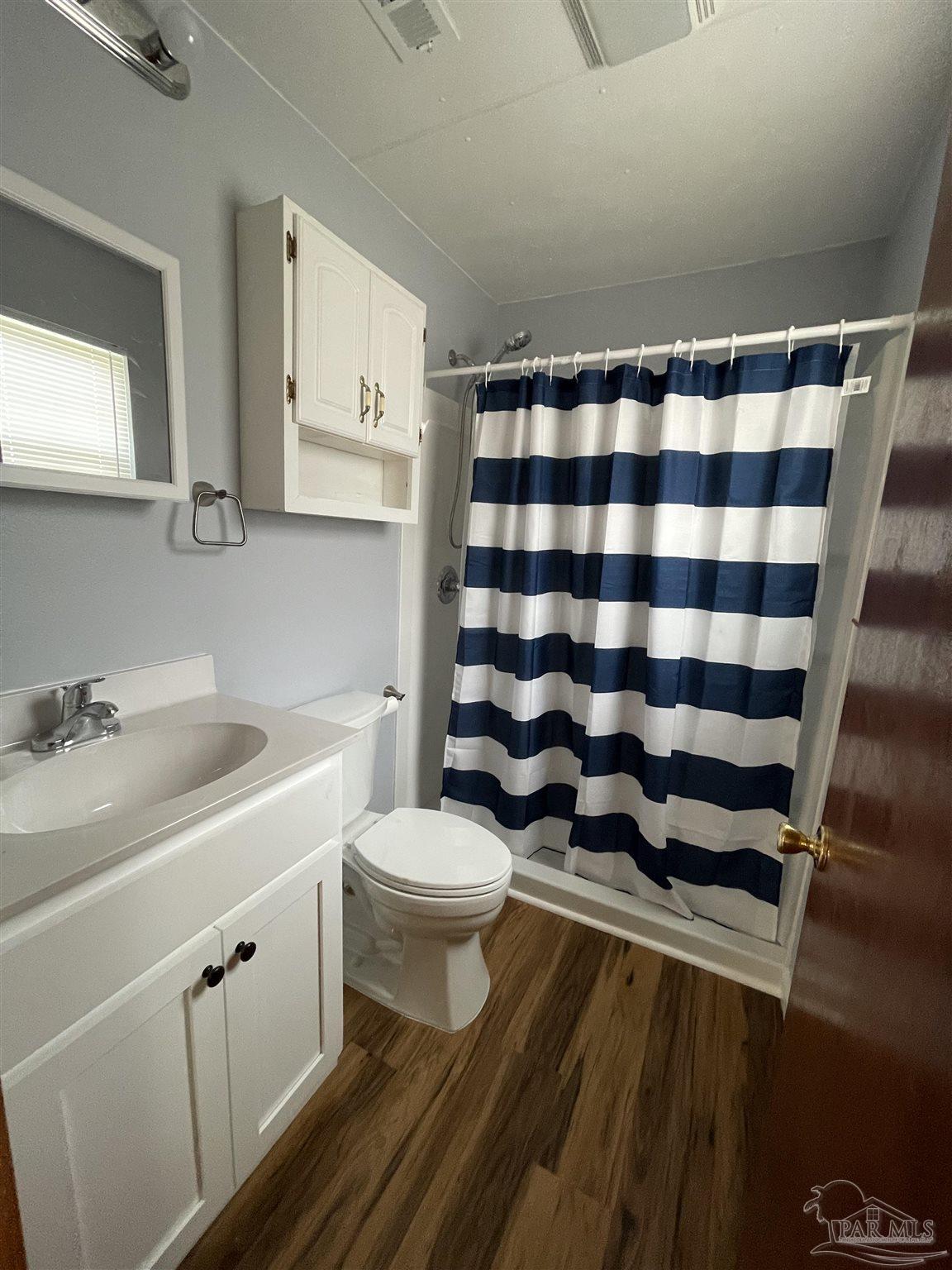 9550 Highway 89 Milton, FL 32570 - Photo 12 of 18 a bathroom with a sink a toilet a shower and a mirror