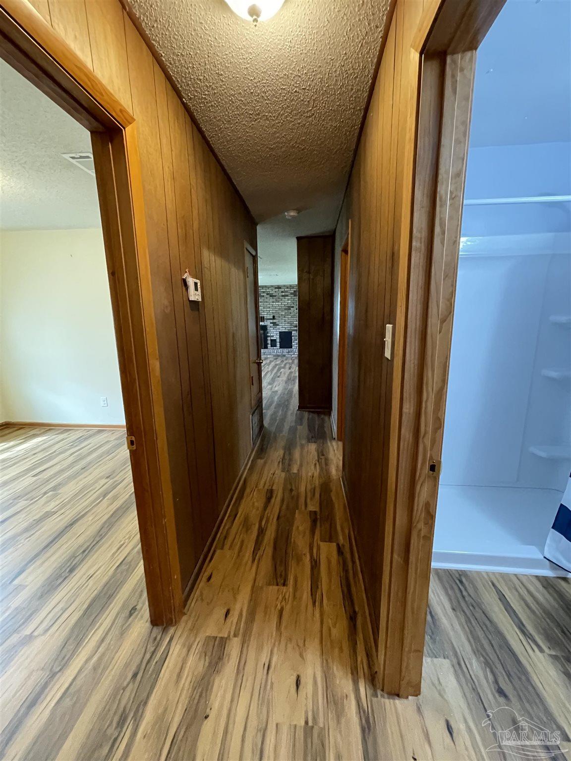 9550 Highway 89 Milton, FL 32570 - Photo 13 of 18 a view of a hallway with wooden floor and staircase