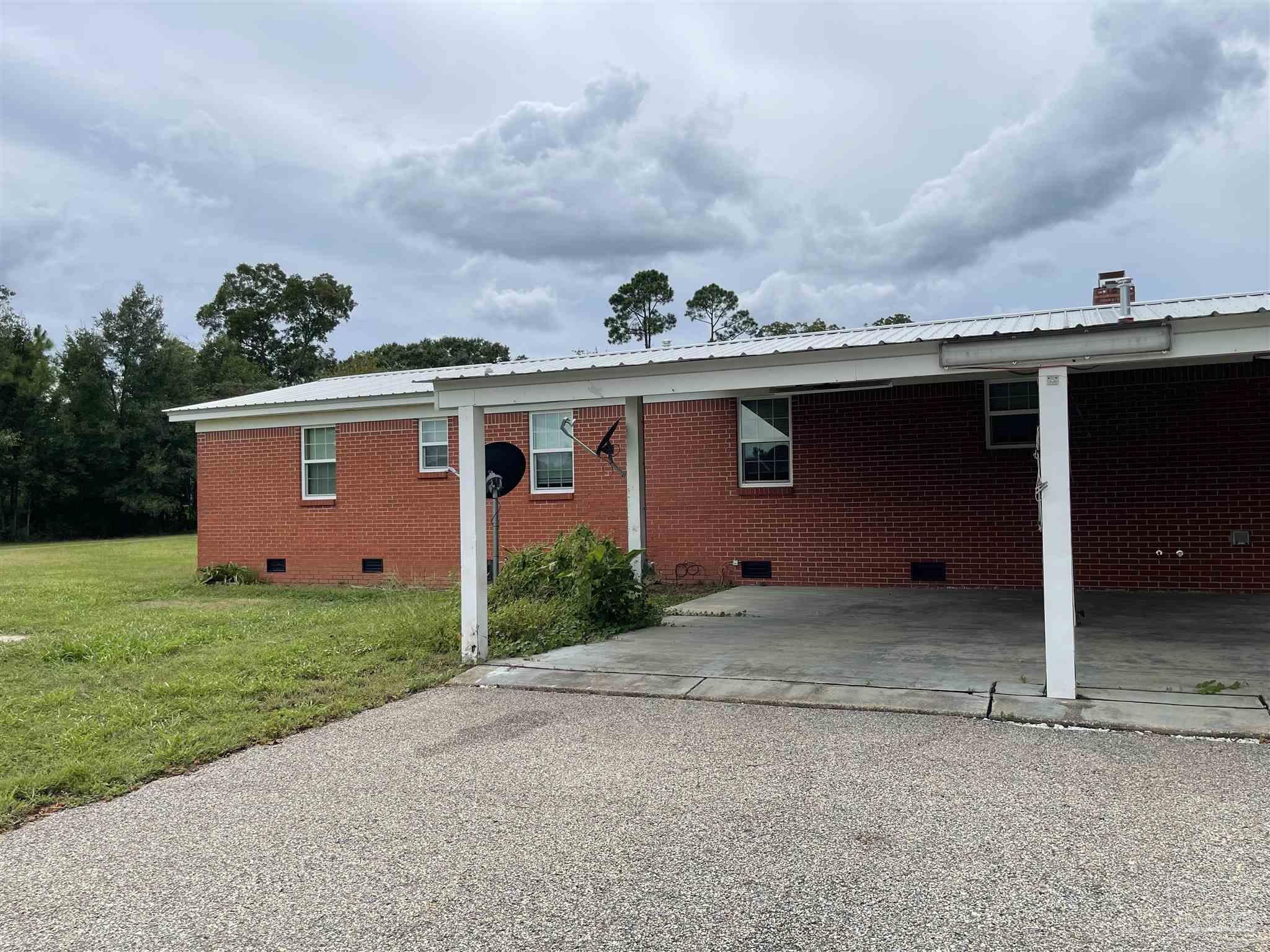 9550 Highway 89 Milton, FL 32570 - Photo 14 of 18 a front view of a house with garden